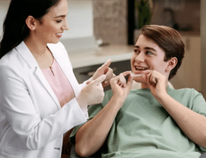 Boy in orthodontist chair getting Invisalign Teen